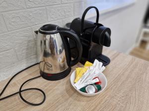 a tea kettle sitting on top of a table at Central Platinum Apartments 29 in Rybnik