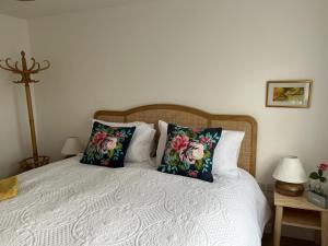 a bedroom with a bed with two pillows on it at Retreat for Two in Shepton Mallet