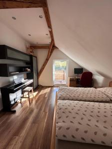 a bedroom with a bed and a desk in a room at PS5, VR2, Logitech racing-Apartmán pod Chočom in Leštiny