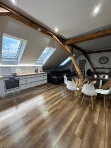 a kitchen and living room with a table and chairs at PS5, VR2, Logitech racing-Apartmán pod Chočom in Leštiny
