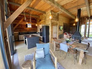 a kitchen and living room with a table and chairs at Grange de Marius - Authentique grange savoyarde in Albiez-Montrond