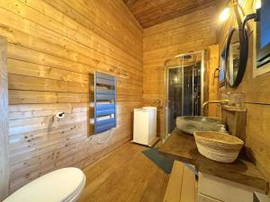 a wooden bathroom with a toilet and a sink at Grange de Marius - Authentique grange savoyarde in Albiez-Montrond +29 photos