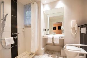 a bathroom with a toilet and a sink and a mirror at Paris Bastille in Paris +66 photos