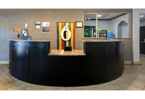 a lobby with a counter with a large letter g at Motel Worth, TX in Fort Worth