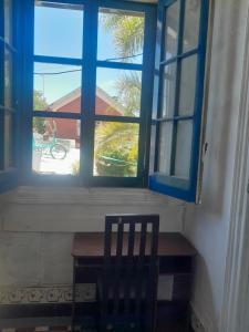 a window with a table and a chair in a room at Canela in Atlántida