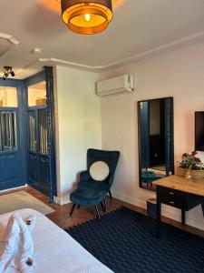 a bedroom with a bed and a chair and a desk at The Blue Suite in Fuengirola