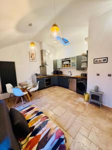 a living room with a couch and a kitchen at Woodland, Canal & Lakeside Cottage in Ellesmere +22 photos