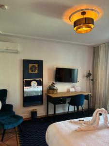 a hotel room with a bed and a desk at The Blue Suite in Fuengirola