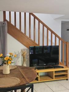 a living room with a tv sitting on a table at La Maison Cérétane in Céret