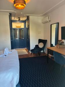 a bedroom with a bed and a desk and a chair at The Blue Suite in Fuengirola