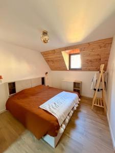 a bedroom with a large bed in a attic at La grange Ausar in Bareilles