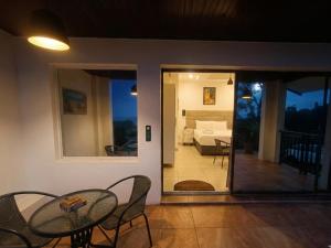 a room with a patio with a table and chairs at Da Vinci - Zur See in Ballito