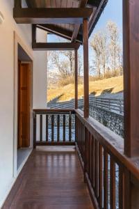 a balcony of a house with a view of the tracks at Casa Tre Corone, sulla strada per Cortina in Borca di Cadore