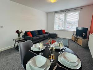 a living room with a dining table and a couch at Curwen Apartment - 2 Bedrooms - Sleeps 6 in Workington