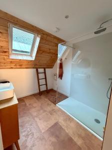 a bathroom with a glass shower in a room at La grange Ausar in Bareilles +20 photos