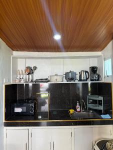 a kitchen with a black counter top and a sink at Villa with Beachfront Access in Lalauigan +7 photos