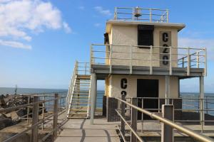 a light house on the beach with a staircase at Curwen Apartment - 2 Bedrooms - Sleeps 6 in Workington