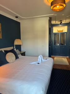 a bedroom with a large bed with a robe on it at The Blue Suite in Fuengirola