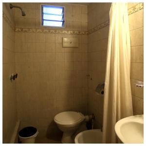 a bathroom with a toilet and a sink at Hotel Los Ángeles in Mar del Plata +42 photos