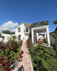 a white building with flowers in front of it at Qafqaz mountain villa in Mekhrably