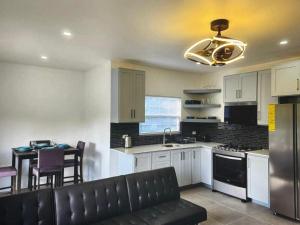a kitchen with a couch and a table in it at Tropical Tobago in Riseland