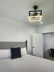 a bedroom with a bed and a ceiling fan at Tropical Tobago in Riseland