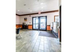 an empty lobby with a door open to a restaurant at Studio 6 Indianapolis, IN - Southport in Indianapolis