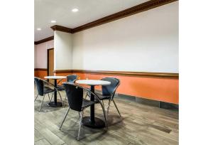 a room with three chairs and a large wall at Studio 6 Indianapolis, IN - Southport in Indianapolis +16 photos