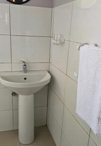 a white bathroom with a sink and a towel at Selamu Self Catering in Walvis Bay +38 photos
