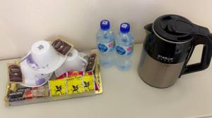 a counter with two bottles of water and a coffee pot at Podshoh guest house in Samarkand