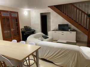 a living room with a couch and a table at Villa Soleil des Caraïbes in Gourbeyre