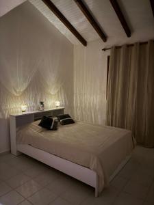 a bedroom with a bed with two pillows on it at Villa Soleil des Caraïbes in Gourbeyre