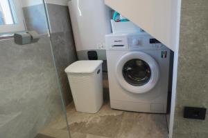 a washer and dryer in a small bathroom at Graziosa, Casetta in Valgerola in Rasura