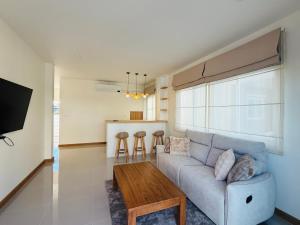 a living room with a couch and a table at House in HangDong in Hang Dong