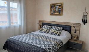 a bed with two pillows on it in a bedroom at Shanaël in Gap