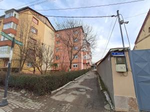 an empty street with a pay phone on the side of a building at "NIB's apartment" in Caransebeş