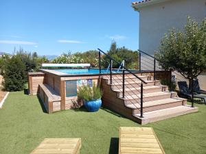 a backyard with a swimming pool and a house at U MANDARINU in Ajaccio