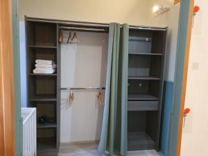 a refrigerator with a curtain in a room at Villa Honorine in Saint-Honoré-les-Bains +36 photos