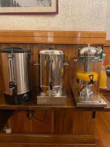a counter with two appliances on a wooden shelf at Hotel Vegas in Santiago