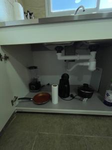a kitchen counter with a sink under a sink at Fully equipped studio apartments in Apóstoles +8 photos