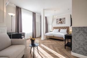 a bedroom with a bed and a desk and a couch at Hotel Alex an der Ahr in Bad Neuenahr-Ahrweiler +77 photos