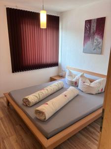 a bedroom with a bed with pillows on it at Ferienwohnung Gritsch Sommercard inclusive in Jerzens