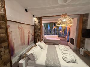 a bedroom with a large bed and a chandelier at Oasi in Kato Loutraki +168 photos
