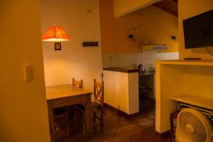 a kitchen with a table and a dining room at Cabañas La Morera in Villa Ventana