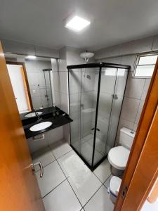 a bathroom with a shower and a toilet and a sink at Studio Easy West Flat in Mossoró +5 photos
