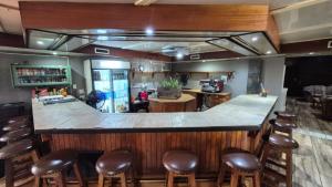 a bar with brown stools in a restaurant at Silhouette Guesthouse in Welkom