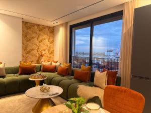a living room with a green couch and a large window at Luxury Studio Casa Center in Casablanca