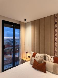 a bedroom with a large bed with a large window at Luxury Studio Casa Center in Casablanca