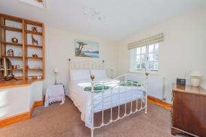 a bedroom with a bed and a desk at Kwerky Cottage in North Lydbury