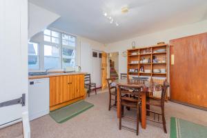 a kitchen and dining room with a table and chairs at Kwerky Cottage in North Lydbury